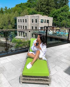 a woman sitting on top of a green couch