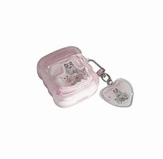 two cats in a pink case with a heart shaped keychain on a white background