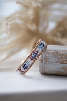 ↠ DESCRIPTION OF THE JEWELRY ↞ This Kwanita wrap bracelet is a tribute to the richness of Native American culture. Each Miyuki bead is carefully selected for its quality and consistency, creating designs inspired by Native American arts and spirituality. The colors of blue, red and white evoke sky, earth and purity, while the patterns tell ancient stories. The result is a piece of jewelry that celebrates the timeless beauty of Native American culture. ↠ SPIRITUAL MEANING ↞ The colors and pattern White Woven Bracelets As Gift, White Hand Wrapped Friendship Bracelets For Festivals, White Hand-wrapped Friendship Bracelets For Festivals, Gift Woven White Bracelets, Gift White Woven Bracelets, Beaded Bracelet As A Gift, White Woven Bracelet For Gift, Bohemian Beaded Bracelets As Gift, White Woven Bracelet Jewelry