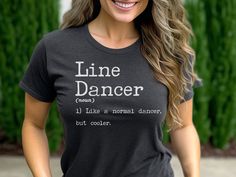 "Elevate your dance game with our \"Line Dancer\" shirt. This witty design celebrates the unique blend of skill and swag possessed by line dancers everywhere. Show off your effortless coolness and make a bold statement that sets you apart from the ordinary dancers. Embrace the groove and let the world know that being a line dancer is all about being cooler than cool. It is printed directly onto a Bella Canvas 3001 shirt, which runs true to size. Size up if you want a roomy fit. This is not a vinyl iron on, the ink is directly infused into the fibers of the fabric This classic unisex jersey short sleeve tee fits like a well-loved favorite. Soft cotton and quality print make users fall in love with it over and over again. These t-shirts have-ribbed knit collars to bolster shaping. The should Fitted Graphic Print Top For Dance, Fitted Hip Hop Dance Tops, Stretch Black Top For Dance Class, Fitted Tops For Dance Class, Black Stretch Top For Dance Class, Fitted Crew Neck Shirt For Dance, Fitted Cotton Shirt For Dance, Fitted Black Top For Dance Class, Fitted Crew Neck Top For Dance