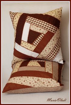 two brown and white pillows sitting next to each other