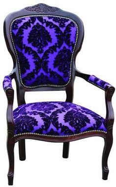 a purple and black chair sitting on top of a white floor