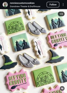 some decorated cookies are sitting on a white counter top with the words deviling gravity written in pink and green