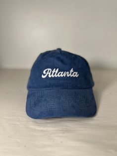 Ultra Soft and Durable Corduroy Hat with Atlanta embroidered on the front Casual Blue Embroidered Trucker Hat, Corduroy Hat With Embroidered Logo For Streetwear, Embroidered Logo Corduroy Hat For Streetwear, Streetwear Corduroy Hat With Embroidered Logo, Casual Corduroy Hat With Curved Bill, Corduroy Baseball Cap With Embroidered Logo, Corduroy Hat With Embroidered Logo And Curved Brim, Casual Corduroy Trucker Hat, Blue Cap With Letter Embroidery