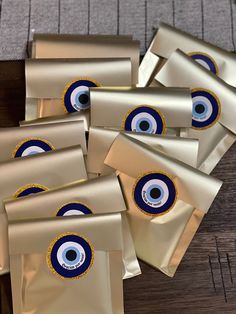 six envelopes with an evil eye on the front and one in the back, are sitting on a table