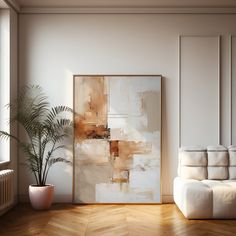 an abstract painting hangs on the wall next to a white couch and potted plant