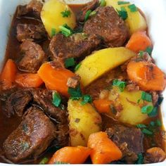 a white bowl filled with meat and vegetables