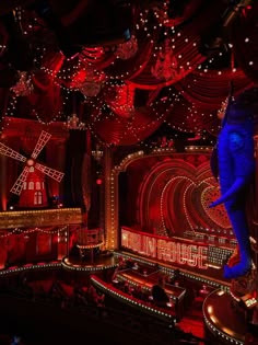 an elephant is standing in the middle of a room with red and blue lights on it