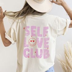 Self love is the motto for 2024 here at D25! we love a good pocket tee and our brand new self love club design is such a cute reminder to love yourself, mama! we are obsessed with the smiley face pocket and cant wait to pair this shirt with jeans or oversized with bike shorts! DETAILS Unisex sizing - aka mens sizing. This fits a little more relaxed than our regular tees. 80/20 ring spun cotton/polyester, 3-end garment-dyed soft ring spun color blast fleece with a 100% cotton face Relaxed fit wit Self Care Shirt Ideas, Self Care Tshirt Ideas, Self Care Shirts, Self Love Merchandise, Self Love Club Sweatshirt, Self Love Club Shirt, Cute Reminder, Shirt With Jeans, Self Love Club