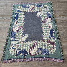 a rug with cats on it laying on the floor