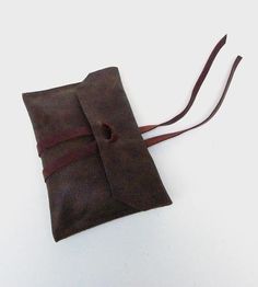 a small brown bag with a leather strap