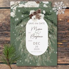 save the date card with pine cones and snowflakes on it, surrounded by evergreen branches