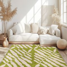 a living room with a large green rug on the floor next to a white couch