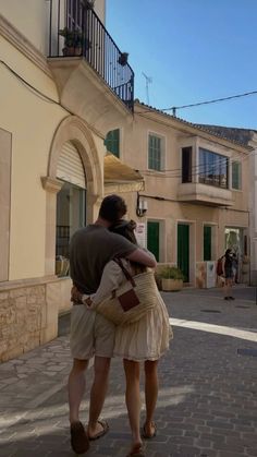 a man and woman hugging on the street