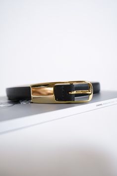 Leather belt Imported Gold-tone push pin buckle closure Modern Black Belt With Rectangular Buckle, Designer Business Belts With Gold Buckle, Luxury Belt With Buckle Closure For Workwear, Luxury Belts With Buckle Closure For Workwear, Black Formal Belt With Buckle Closure, Formal Black Belt With Buckle Closure, Elegant Black Rectangular Belt Buckle, Elegant Rectangular Belt Buckle For Workwear, Black Business Belt With Buckle Closure