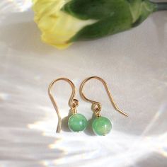 💚 Tiny Jade Ball Drop Earrings with 6mm Jade and 14K gold-filled or Sterling Silver wire. ✨ Jade is believed to bring good luck. Jade is thought to have protective, lucky-charm energy ✨ • Handmade with genuine Jade beads (6mm) and high-quality wire • 14K gold-filled wire is known for its lasting quality. These cute earrings will last for decades and are considered lifetime pieces of jewelry. • These earrings won’t tarnish. You can wear them every day. • Hypoallergenic. You won’t have to worry a Ball Drop Earrings, March Birthstone Necklace, Emerald Green Earrings, Gold Pearl Ring, Rose Gold Pearl, Emerald Earrings Studs, Ball Drop, Sterling Silver Wire Wrap, Jade Earrings