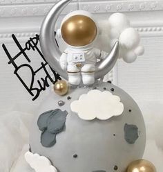 an astronaut is sitting on top of the moon with clouds and stars around him, as if he was celebrating his birthday