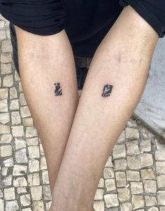 two people with matching tattoos on their legs