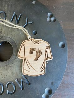 a wooden ornament with a t - shirt on it