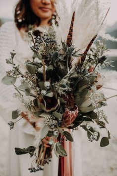 a woman holding a bouquet of flowers in her hands