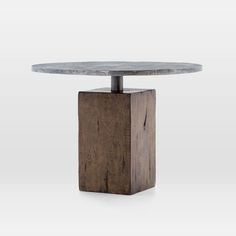 a round table with a wooden base and grey marble top on an isolated white background