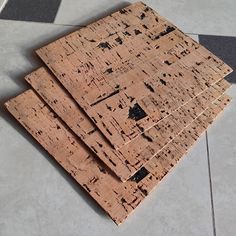 three pieces of wood sitting on top of a tile floor