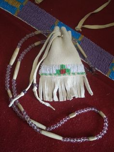 Plains Indian style medicine bag, Amulett pouch, made of deer leather, bone hairpipes and Glass beads. The bag is ca 13x8,5 cm, the necklace ca 77 cm long. Traditional Beaded Necklaces As Gift, Traditional Natural Beaded Necklaces As Gift, Traditional Natural Beaded Necklaces For Gifts, Traditional Natural Beaded Necklace Gift, Bohemian Beaded Bag As Gift, Bohemian Beaded Bags For Gifts, Traditional Handmade Jewelry For Everyday Use, Handmade Spiritual Bag For Festivals, Amulet Bag