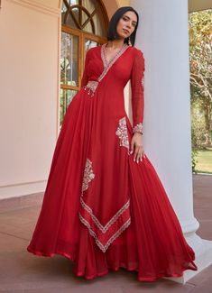 Elevate your ethnic wardrobe with the exquisite Red Layered and Embroidered Anarkali Gown, a perfect blend of tradition and contemporary style. Crafted from luxurious georgette and organza, the red gown showcases a timeless layered design with an elegant drape. Intricately adorned with tilla work, dori, pearls, handmade tassels, brass sequins, and bead embroidery, this outfit is a masterpiece of craftsmanship. The ensemble is complemented by an attached embroidered belt and a soft net dupatta, adding a touch of sophistication and elegance. Ideal for a bride or bride to be to usher in the wedding festivities. Composition : Anarkali - Georgette and Organza, Dupatta - Soft Net Care: Dry Clean Only and Vacuum Storage This product can be customized for sleeves, length and colour Delivery : 4-6 Anarkali Georgette, Isha Gupta, Embroidered Anarkali, Wedding Festivities, Embroidered Belt, Vacuum Storage, Indian Wedding Wear, Anarkali Gown, Elegant Drapes