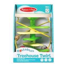 a green and yellow treehouse toy in a cardboard box