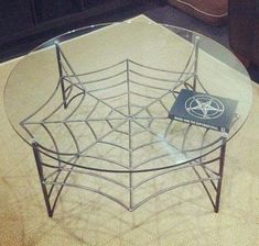 a glass table with a spider web design on it