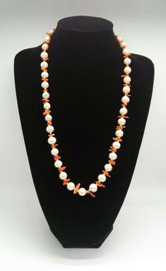 An absolutely stunning cultured pearl necklace enhanced with coral and gold beads. The pearls are of a super quality and colour and measure approx 1cm. The fixings and the beads are of 18ct gold (fully tested) Pearls are the birthstone for June or a third wedding anniversary, what a wonderful gift or treat this necklace would make. Length 27 inches 68 1/2 cms If you would like more details and or photographs please message me and I will be happy to answer any questions  The items for sale are in Elegant Orange Pearl Necklace Gift, Elegant Beaded Red Coral Pearl Necklace, Elegant Red Coral Beaded Pearl Necklace, Gift Coral Beaded Pearl Necklace, Coral Beaded Pearl Necklace As Gift, Elegant White Red Coral Necklace, Elegant Coral Pearl Necklace With Round Beads, Orange Pearl Necklace As A Gift, Orange Pearl Necklace As Gift