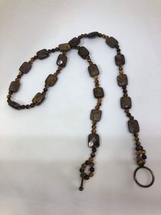 Faceted Bronzite and tigers eye round beaded necklace with bronze toggle clasp Brown Necklace With Round Beads And Lobster Clasp, Brown Round Necklace With Lobster Clasp, Eye Round, Waiting For Someone, Unisex Necklace, Ball Necklace, Change Of Heart, Modern Urban, Tigers Eye