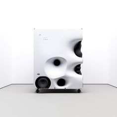 the speakers are stacked on top of each other in front of a white wall and floor