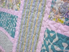 a close up view of a quilted wall hanging