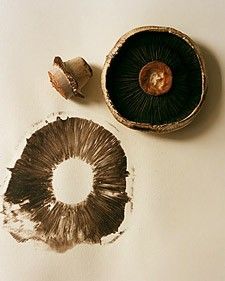 two pieces of wood sitting on top of a white table next to a piece of metal