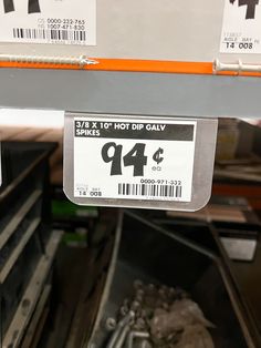 a close up of a price label on a shelf in a store with other items