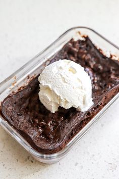 a chocolate dessert with ice cream in a glass dish