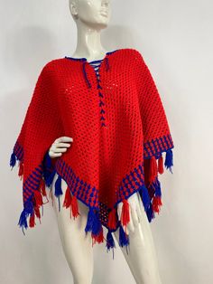 "Crochet knit poncho, knit poncho, red and blue knit, beautiful hand knit poncho  Measurements:  Lying flat width corner to corner 59\"/length from middle to bottom corner 26\"/length of sides 40\" Mannequin measurements:  5'8\", bust 34\", waist 25\", hip 33\" Please note that vintage clothing sizes can vary greatly.  The Measurements provided  are approximate and are taken lying flat.  I suggest taking a similar garment from your wardrobe and measure it while lying flat.  This way you can comp Traditional Red One-size Poncho, Traditional Red Poncho For Fall, Traditional Red Fall Poncho, Red One-size Poncho Cape, Red One Size Cape Poncho, Red One-size Cape Poncho, One Size Acrylic Poncho Shawl, Red One-size Cape Shawl, Traditional Blue One-size Poncho