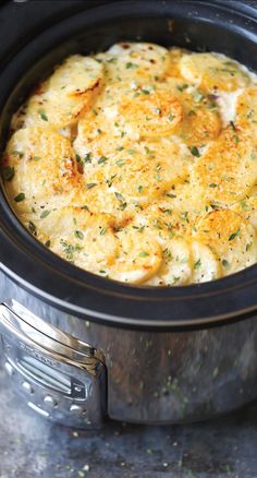 a crock pot filled with food sitting on top of a stove