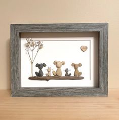 three stuffed animals are sitting on a shelf next to a flower and a framed photo