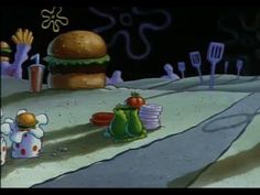 an animated image of a hamburger and other food items on the ground with utensils