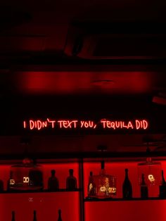 a red neon sign that reads, i didn't text you tequila did