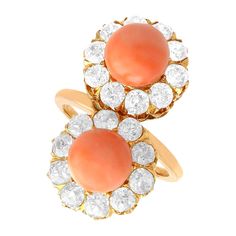 A stunning antique 6.06 carat coral and 2.86 carat diamond, 18 karat rose gold dress ring; part of our diverse antique jewelry and estate jewelry collections. This stunning, fine and impressive antique coral ring has been crafted in 18k rose gold. The pierced decorated twist style setting displays two bead cut corals, totalling 6.06Ct. Each coral is each encircled by ten claw set Old European cut diamonds, totalling 2.86Cts. The elevated ring shoulders integrate with the main setting and blend s Antique Gemstone Rings, Diamond Dress Ring, Rose Gold Dress, Diamond Dress, Twist Style, Gold Cocktail Ring, Coral Ring, Gold Cocktail, Dress Rings