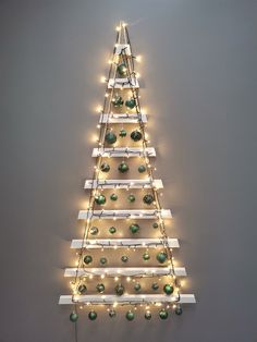 a christmas tree made out of shelves with lights