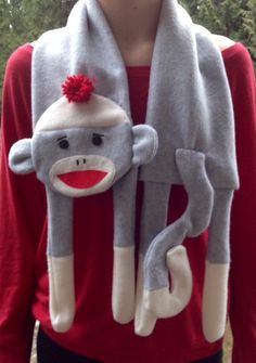 a person wearing a red and gray monkey costume with a sock on it's back