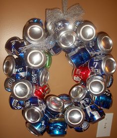 a wreath made out of cans is hanging on the wall