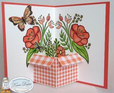 an open card with flowers and butterflies on the front, in red and white checkered paper