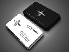 two black and white business cards sitting on top of each other in front of a gray background