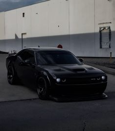 a black sports car parked in front of a building