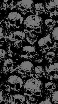 a bunch of skulls that are all over the place with black and white paint on them